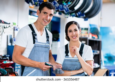 Woman and man as bike mechanics in workshop - Powered by Shutterstock