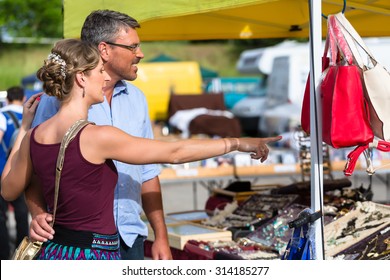 Woman And Man Buying Stuff On Flea Market