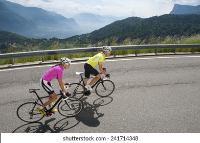 Woman And Man By Uphill With Road Bike