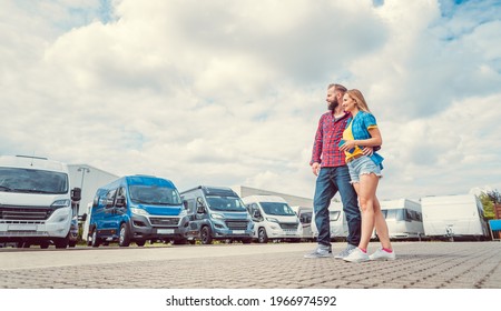 Woman and man choosing camper van to rent or buy - Powered by Shutterstock