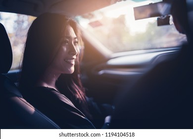 Woman And Man Enjoying To Travel. Asian Couple Sitting On The Front Passenger Seats ,she Smiling While  Driving A Car  On The Road