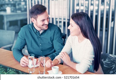 Woman And Man Flirting In A Cafe. Love And Romance