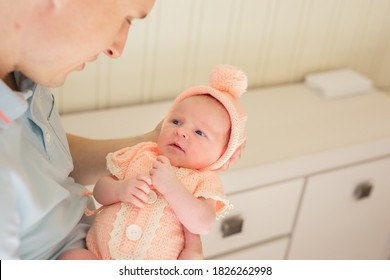 Woman And Man Giving A Newborn Baby. Mom, Dad And Baby. Close-up. Portrait Of A Young Smiling Family With A Newborn Baby In Their Arms. Happy Family On The Background.