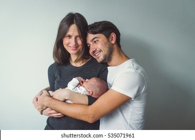 Woman and man holding a newborn. Mom, dad and baby. Close-up. - Shutterstock ID 535071961