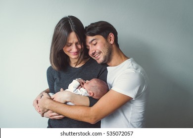 Woman and man holding a newborn. Mom, dad and baby. Close-up. - Shutterstock ID 535072057