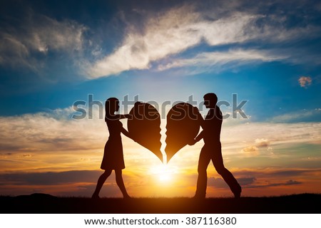 Woman and man holding two halves of broken heart going to be joined in one. Love conceptual.