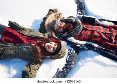 Woman And Man Making Snow Angel 