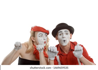 Woman And Man Peeking Over An Invisible Fence. Big Eyes, Awe And Amazement. Emotional Mime Couple On White.