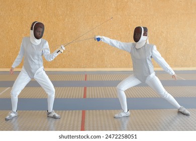 woman and man practicing fencing - Powered by Shutterstock