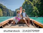 woman and man sitting at the bow of the boat Come to the sea of ​​Samet Nangshe Phuket Thailand