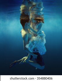 Woman And Man Swimming Underwater