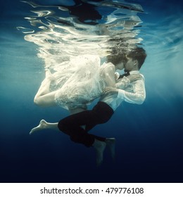 Woman And Man Swimming Underwater