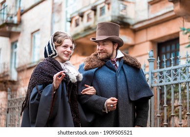 The woman and the man in vintage suits. People in retro dresses. Walking on the street