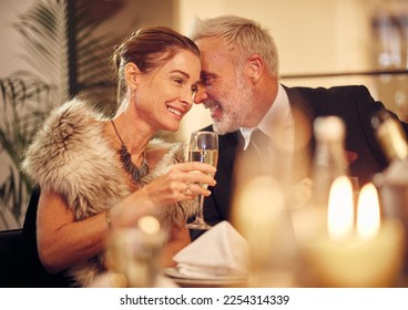 Woman, man and whisper at dinner, party or restaurant for celebration in night with smile, happy and gossip. New year, fine dining or gala event with champagne, conversation and romantic secret love