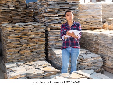 Woman Manager Of A Hardware Store Keeps Records Of Natural Stone Tiles