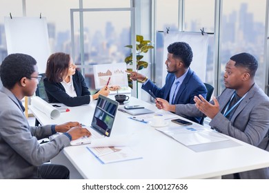 Woman manager is showing annual report chart to her African American colleagues in the executive meeting for next year plan with city skyline background for global business and investment - Powered by Shutterstock