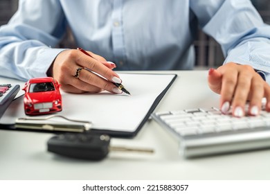 Woman manager sitting at a desk with documents typewriter keys and keyboard. Car and life insurance for drivers. A woman in the office. Desktop - Shutterstock ID 2215883057