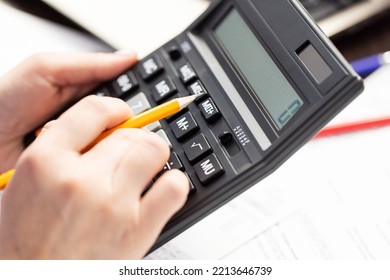 A Woman Is Managing Household Family Expenses Using Calculator