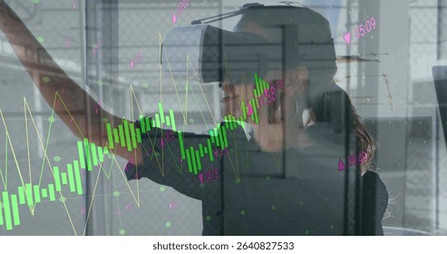 Woman manipulating charts using VR headset in conference room, with glass partition. Futuristic, immersive, analytics, innovation, technology, corporate, sleek