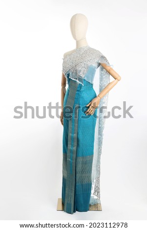 The woman mannequin wearing Thai dressed on the white background.