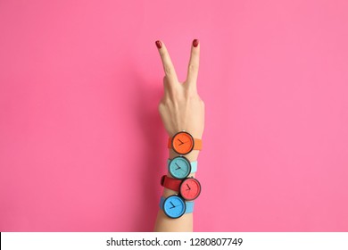 Woman with many bright wrist watches on color background, closeup. Fashion accessory - Shutterstock ID 1280807749