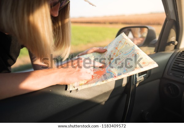 woman with map in\
road trip, hiking in\
nature
