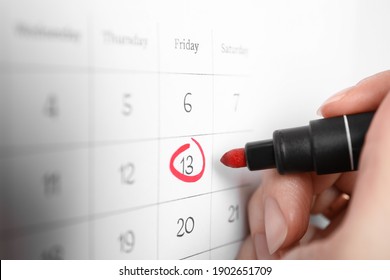 Woman Marking Friday 13th On Calendar, Closeup. Bad Luck Superstition