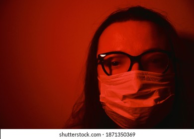 Woman With Mask And Foggy Glasses. Female Can't See Because Of Her Breath Closing The Glasses. Dark Concept Photo. Copy Space Available.