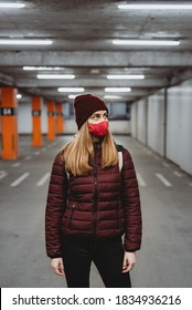 Woman With Mask And Hat In Empty Garage