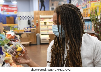 Woman In A Mask Shops At A Grocery Store.