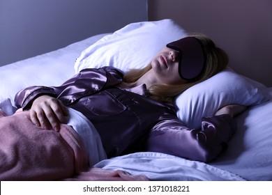 Woman With Mask Sleeping In Bed At Night