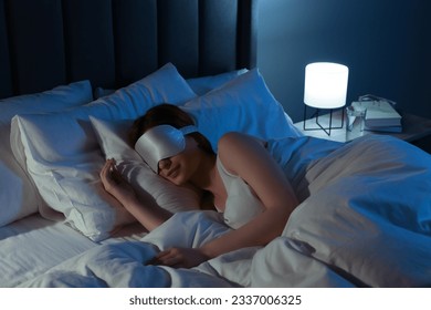 Woman with mask sleeping in bed at night - Powered by Shutterstock