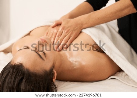 a woman massaging the chest of another woman lying on a stretcher
