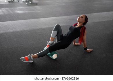 Woman Massaging Foam Roll Leg Gym Myofascial Release Exercise Rolling, Trigger Points Middle Adult Caucasian Woman Sportswoman Uses Roller Massager For Relaxation, Stretching Muscles And Back Pain. 