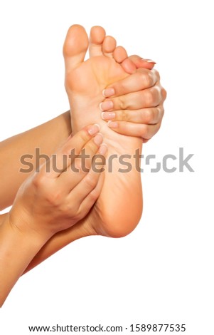 woman massaging her painful foot on white background