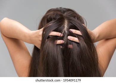 A Woman Is Massaging Her Scalp.