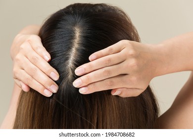 A Woman Is Massaging Her Scalp.