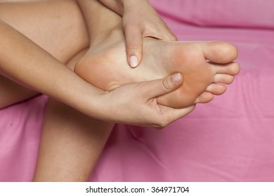 Woman Massaging Her Tired Feet