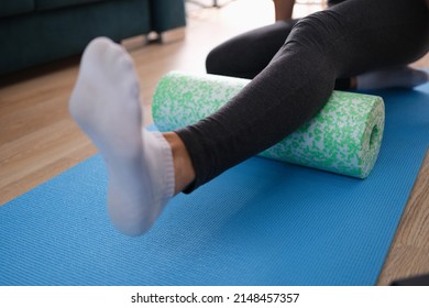 Woman Massaging Leg With Foam Roller Closeup