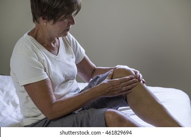 Woman Massaging Painful Knee