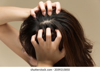 A Woman Is Massaging The Scalp.