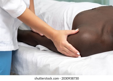 Woman Masseuse Doing Massage Of Shoulder Area Of Hand To Black Man 