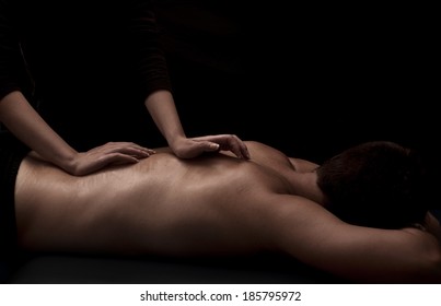 Woman Masseuse Giving A Man A Back Massage