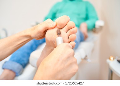 Woman Master Pedicures A Man. Hardware Pedicure. Leg Close Up. A Man Sits In A Pedicure Chair