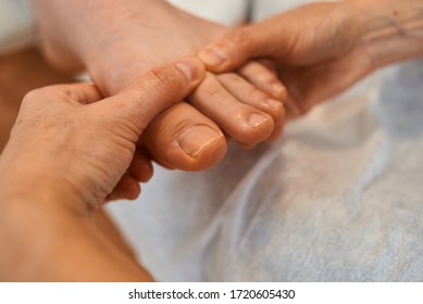 Woman Master Pedicures A Man. Hardware Pedicure. Leg Close Up. A Man Sits In A Pedicure Chair