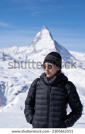 Woman with Matterhorn mountain in the Morning. Zermatt, Switzerland.