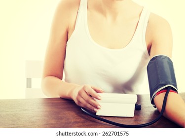 Woman Measures Her Blood Pressure.