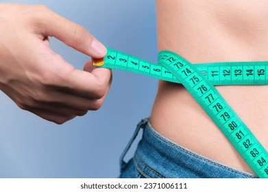 https://image.shutterstock.com/image-photo/woman-measures-her-waist-tape-260nw-2371006111.jpg