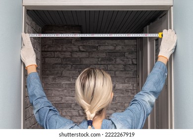 woman measuring a doorway with a tape measure. woman using a tape measure. woman doing house renovation - Powered by Shutterstock