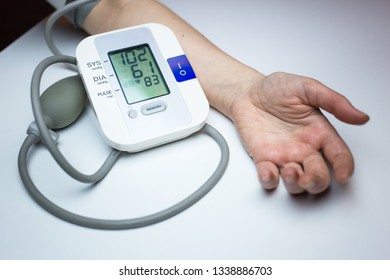 Woman Measuring Her Blood Pressure. Pulse Measuring Device Showing Low Blood Pressure Reading. Hypotension. Heart Health, Healthcare And Medical Concept, Self-care